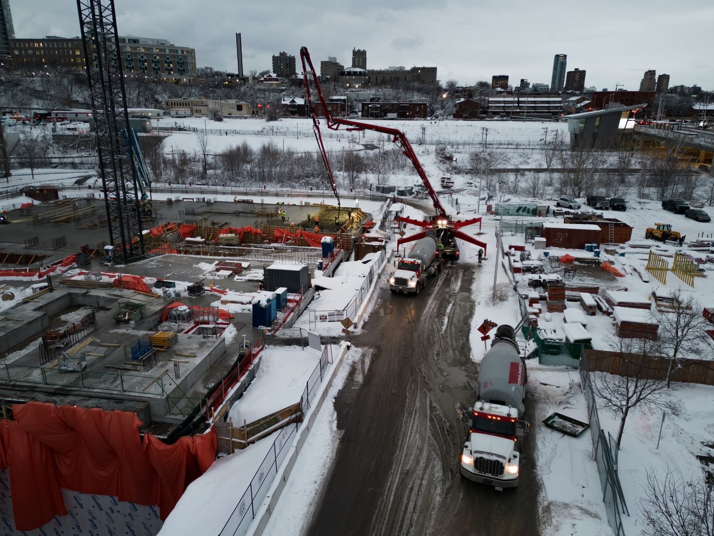 Oblique aerial photograph of an active construction site with concrete pump and mixers